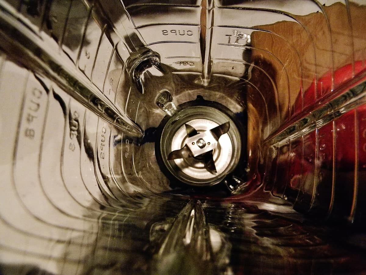 Looking down into an empty blender jar at the blade assembly at the bottom