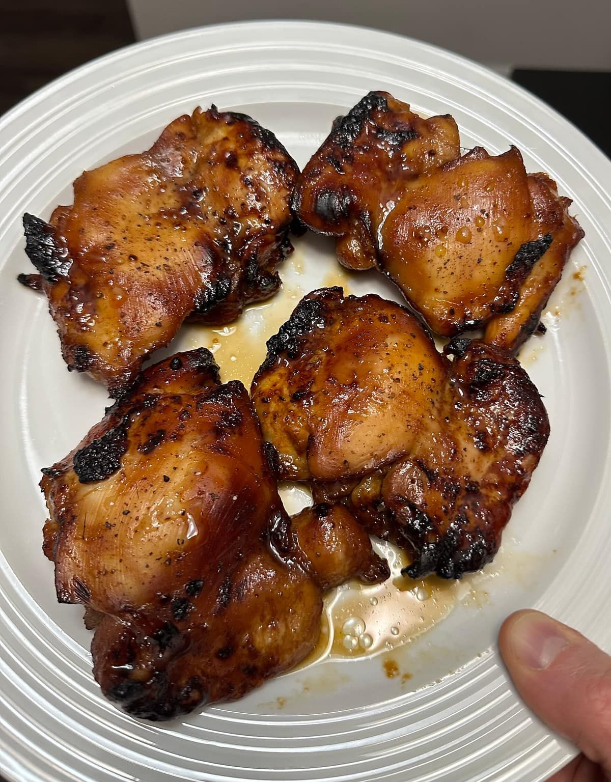 Plate of browned teriyaki chicken thighs cooked in an air fryer